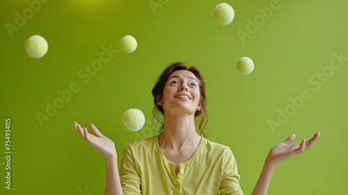 Woman juggling balls a skillful display on a lively lime green background a metaphor for multitasking with ample copyspace photo