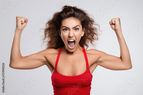 A woman in a red tank top is angry and throwing her hands up in the air photo