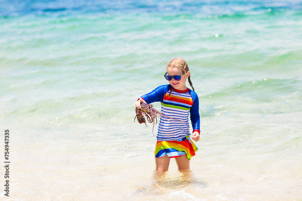 Girl catching fish. Kids fishing on tropical beach Girl catching fish. Kids fishing on tropical beach
