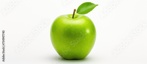 A green apple, a staple food and superfood, with a green leaf on a white background. A natural product from a flowering plant, locally grown and a delicious example of fresh produce