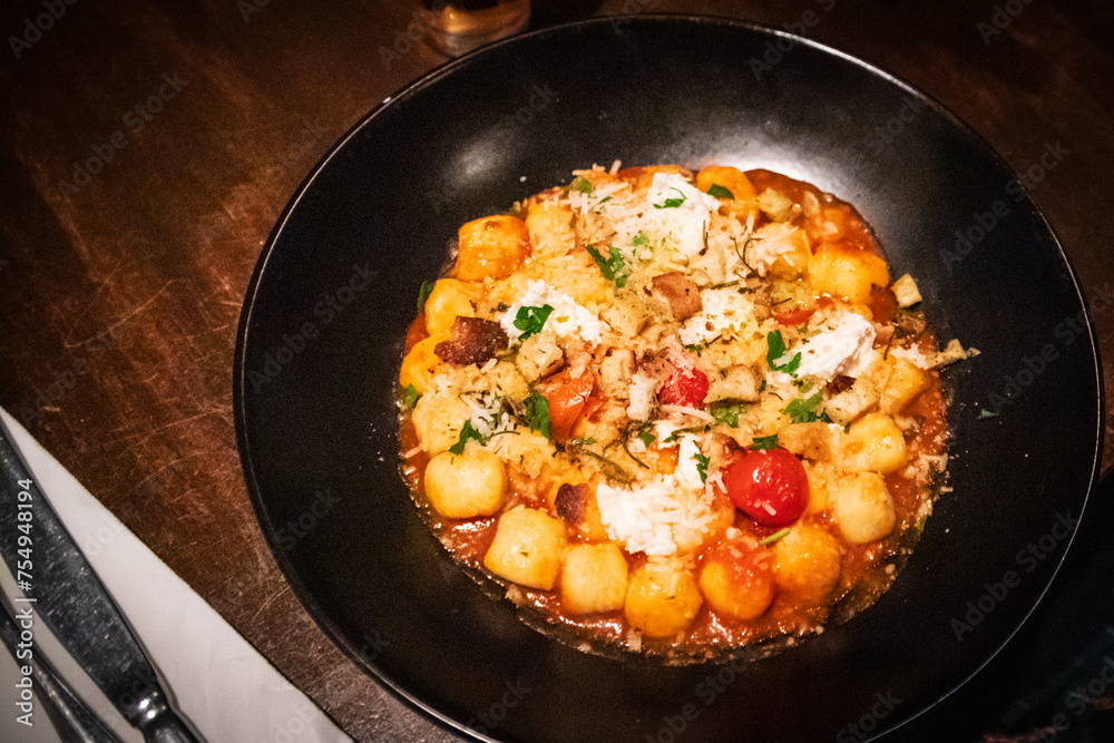 Gourmet Gnocchi Dish Garnished with Fresh Herbs and Cheese