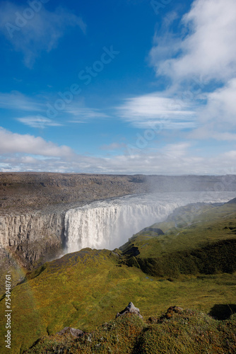 Majestic rainbow over Dettifoss waterfall in Iceland  the second most powerful waterfall in Europe  on a spring day