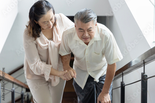 Asian Senior Couple Dealing with Knee Joint Problem, senior couple, husband and wife staying together with support and care concept