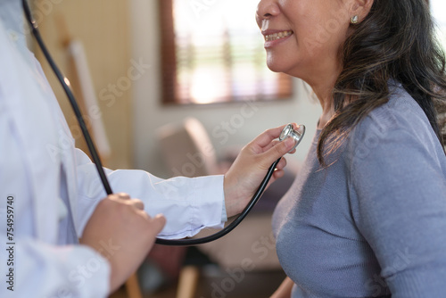 Close-up of a medical doctor using a stethoscope on a patient. Health assessment concept © amnaj