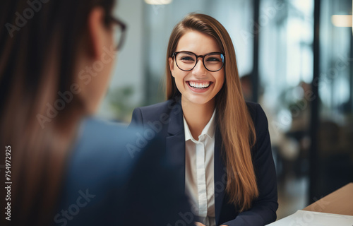 A woman in a business suit is smiling at the camera