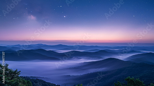 The sky is a beautiful shade of purple and the mountains are covered in fog. The stars are twinkling in the sky, creating a peaceful and serene atmosphere