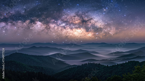The sky is filled with stars and the mountains are covered in fog. The scene is serene and peaceful  with the mountains and sky creating a sense of calmness and tranquility