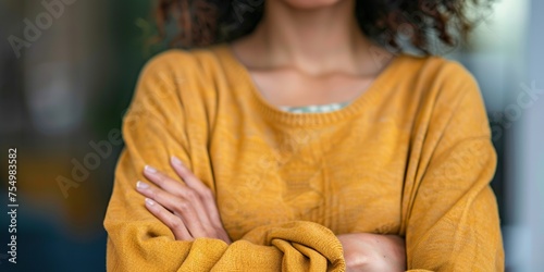Close-up of a person with crossed arms, body language indicating defensiveness or resistance to opening up in a difficult conversation , concept of Nonverbal communication photo