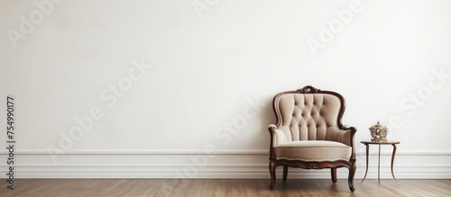 A timeless chair in a classic style is positioned in front of a plain white wall. The room exudes a vintage ambiance with its minimalist decor. photo