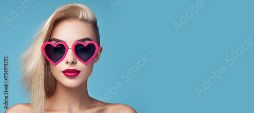 Young woman with blonde hair wearing big heart shaped pink sunglasses portrait, retro style concept make up, banner, copy space