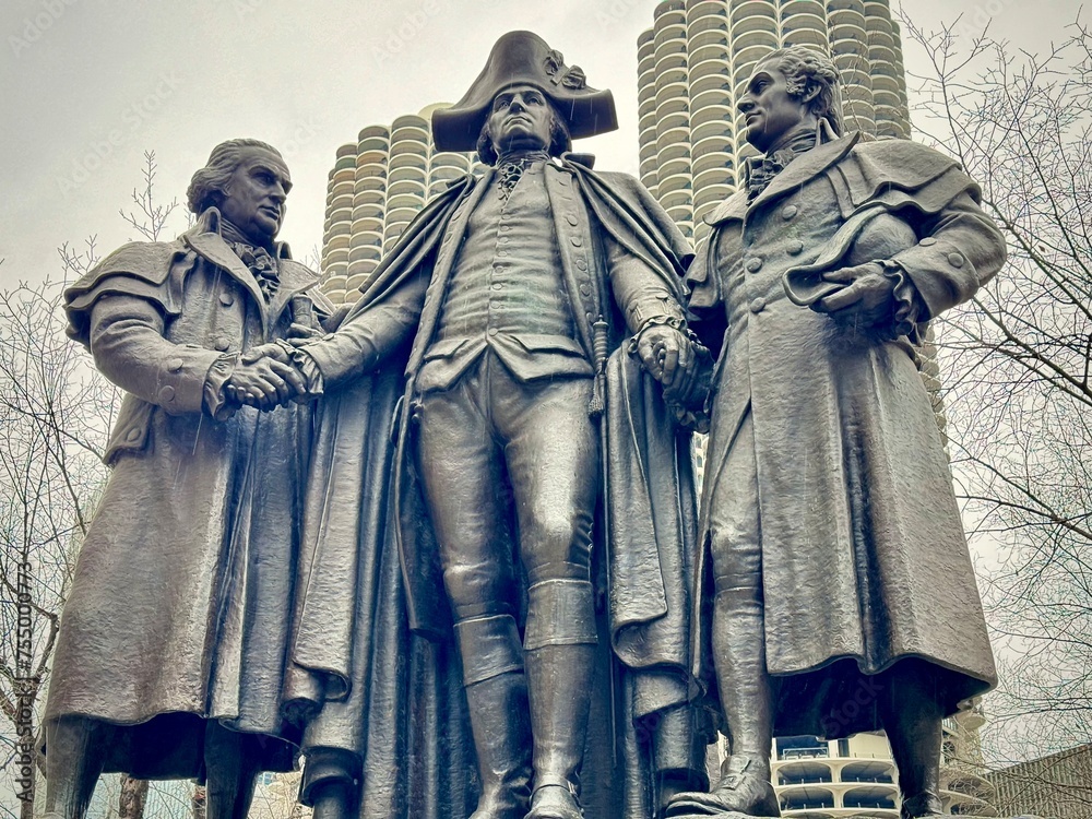 Fototapeta premium close-up of statues of iconic Chicago characters with the city's buildings in the background 