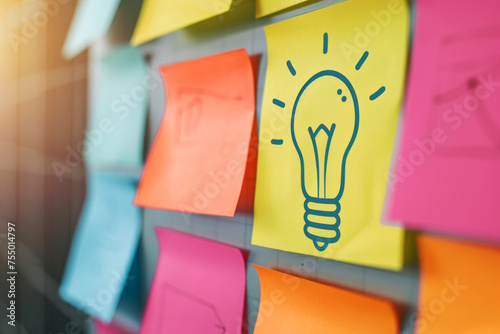 Creative Brainstorming Concept with Lightbulb Drawing on Colorful Sticky Notes photo