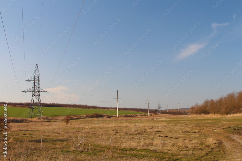 Power lines in a field with Codrington Wind Farm in the background
