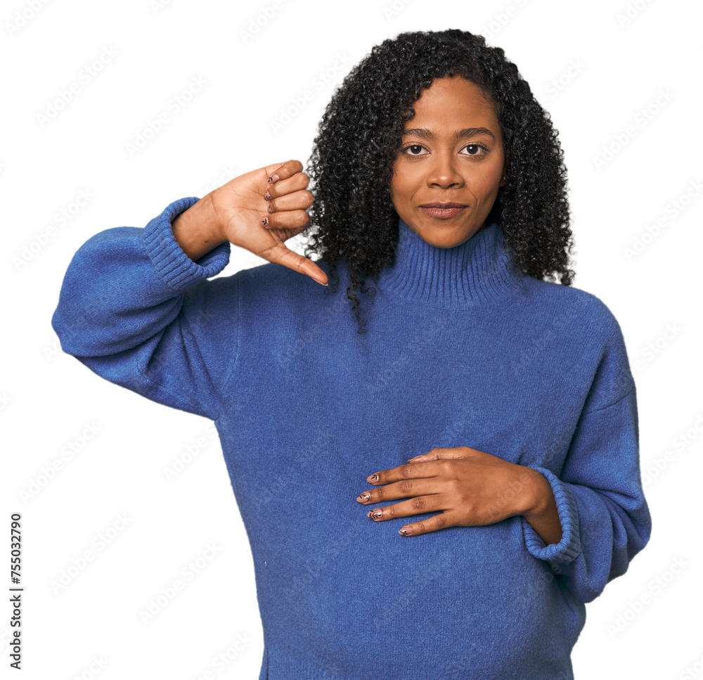 Pregnant African American woman in studio showing a dislike gesture, thumbs down. Disagreement concept. Pregnant African American woman in studio showing a dislike gesture, thumbs down. Disagreement concept.