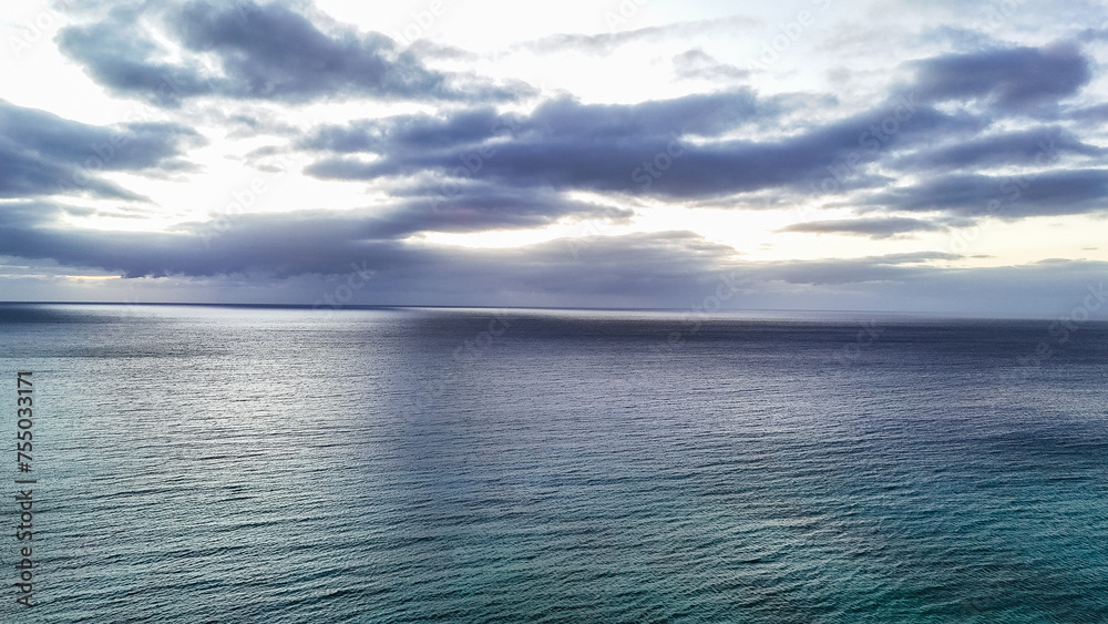 cloudy sky over the ocean with a great pattern on the surface cloudy sky over the ocean with a great pattern on the surface
