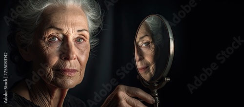 Contemplative Woman Gazing at Her Reflection in a Magnified Mirror photo