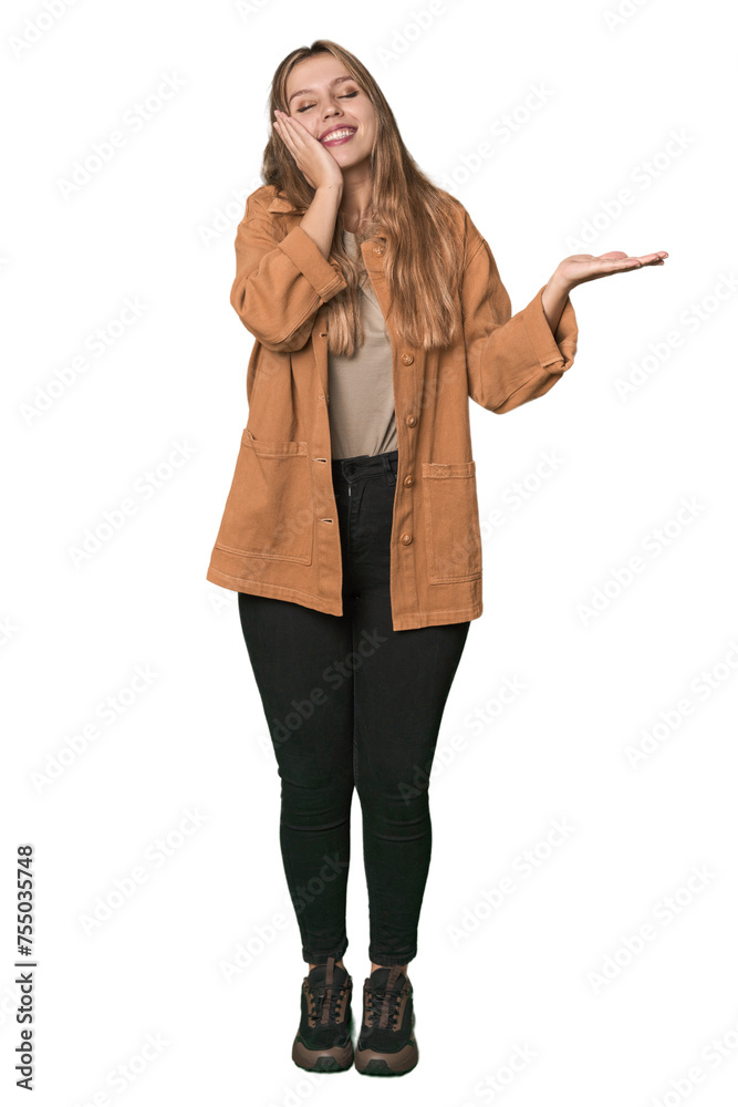 Studio portrait of a blonde Caucasian woman holds copy space on a palm, keep hand over cheek. Amazed and delighted. Studio portrait of a blonde Caucasian woman holds copy space on a palm, keep hand over cheek. Amazed and delighted.