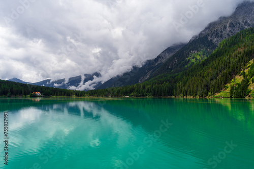 Mystic Antholzer See Surrounded by Alpine Mountains on a Cloudy Day