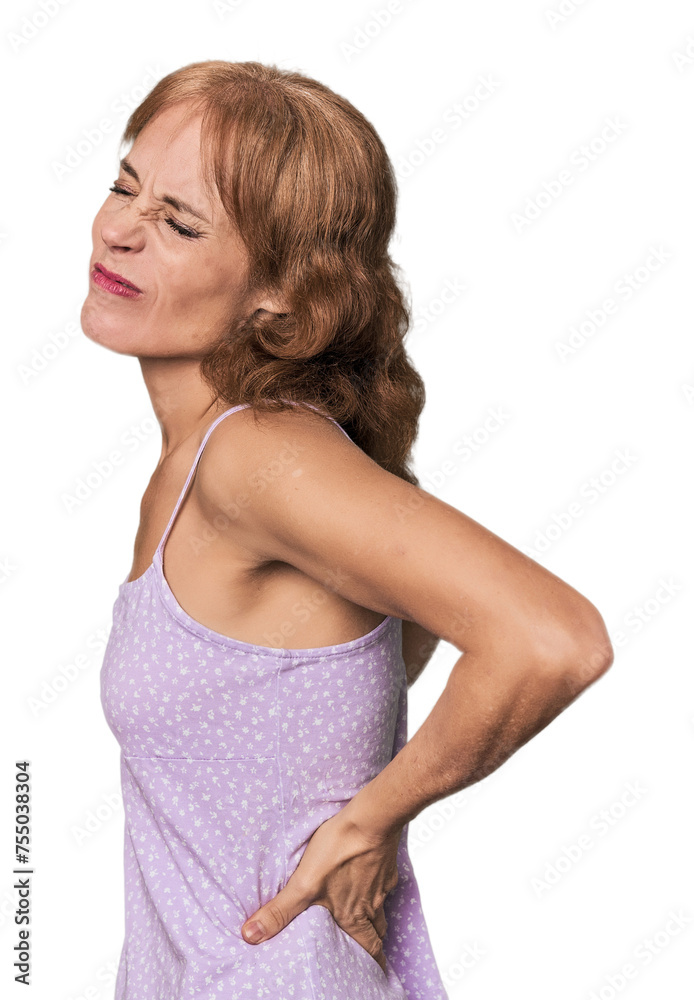 Redhead mid-aged Caucasian woman in studio suffering a back pain. Redhead mid-aged Caucasian woman in studio suffering a back pain.