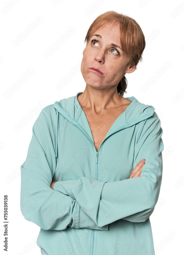 Young mid-aged woman in sportswear in studio tired of a repetitive task. Young mid-aged woman in sportswear in studio tired of a repetitive task.