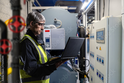 Man near gas boiler equipme...