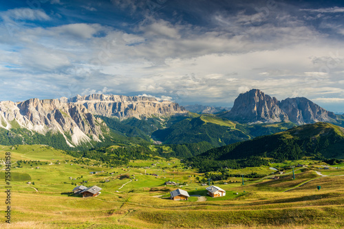 View from Seceda mountain on the Val Gardena in the Italian Dolomites in sunny sumer day with green grass and blue sky with clouds. photo