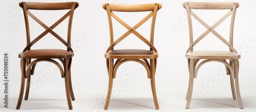 A set of three wooden chairs are placed next to each other in a contemporary living room. The chairs exhibit a modern design, adding a touch of elegance to the space.