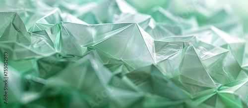 A closeup shot of a grass green origami paper with an intricate geometric pattern. The transparent material gives it a unique look, resembling electric blue hues