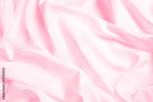 Waves and patterns of crumpled natural satin pink color fabric.