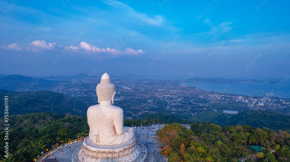 Obraz premium Back view of statue big Buddha in on sunset sky, aerial photo by drone. Concept landmark of Phuket, travel in Thailand