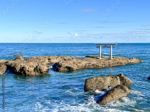 Torii of Ooarai Isosaki Shrine, A rocky shoreline with a small shrine on top of a rock photo