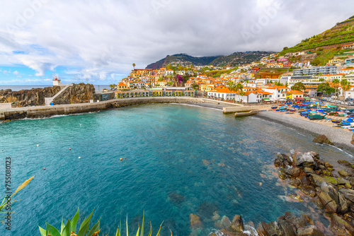 The picturesque seaside fishing village of C  mara de Lobos  Portugal  Canary Islands  with it s pebble beach and colorful town of shops and cafes.