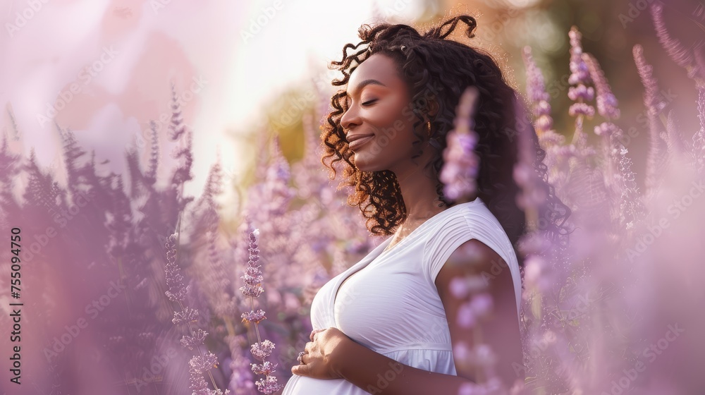 Serene pregnant woman enjoying nature among purple lavender flowers. Maternity photoshoot concept with natural outdoor backdrop