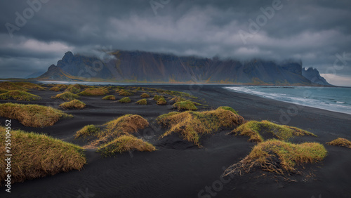 An unusual beach of black volcanic sand at sttormy day