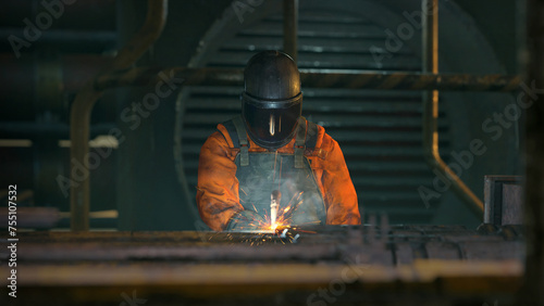 Men at work welding with applied safety measures