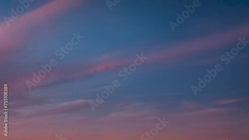 Romantic pastel sky with clouds at beautiful sunset as natural background © rasica