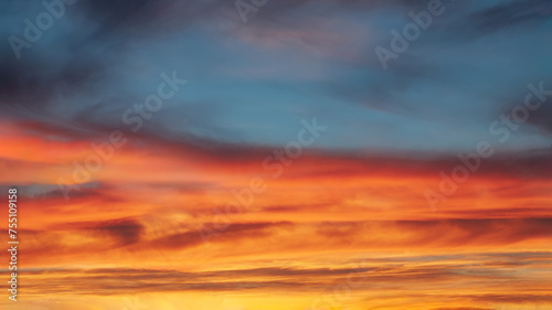 Spectacular vibrant sky with clouds at beautiful sunset as natural background