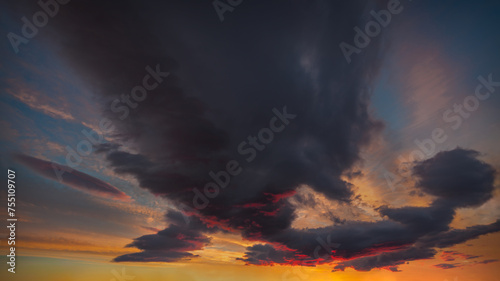 Unusual colorful sky with clouds at beautiful sunset as natural background