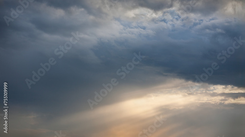Upcoming storm clouds at beautiful sunset as natural background