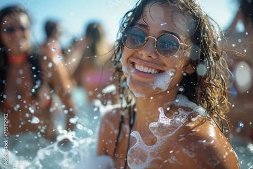 A woman with long hair is smiling and splashing water on herself. Summer foam party concept