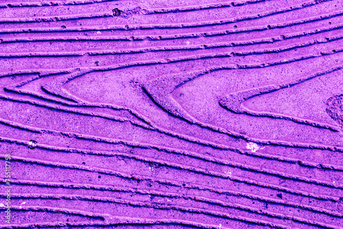 Abstract background made of purple plaster with a pattern.