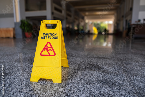Wet floor caution sign on a slippery floor at the indoor public hallway photo