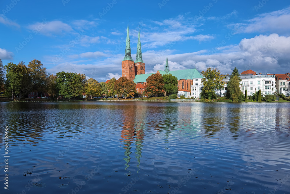 Lubeck, Germany. View of Lubeck Cathedral from the opposite shore of Muhlenteich (Mill pond) in autumn day. The cathedral was started in 1173 and consecrated in 1247.