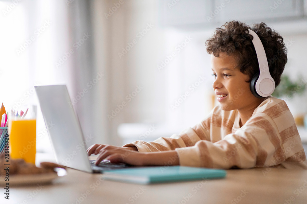 E-Learning. Happy Black Schoolboy Studying Online With Laptop At Home E-Learning. Happy Black Schoolboy Studying Online With Laptop At Home