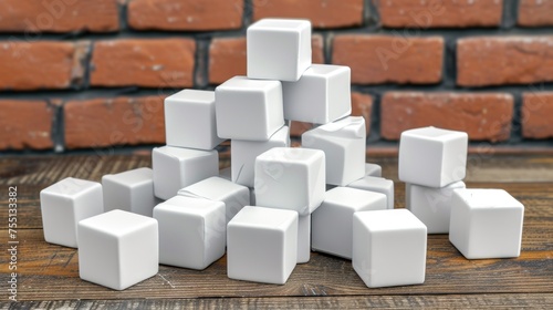 a pile of white cubes sitting on top of a wooden table next to a brick wall with a brick wall in the background.