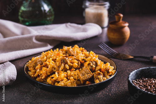 Delicious Asian pilaf with meat on a plate on the table