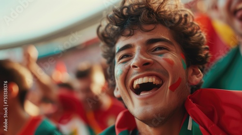 A fan wearing a hat joyfully shouts and waves the Portuguese flag in the stadium among the entertained crowd during the event. AIG41