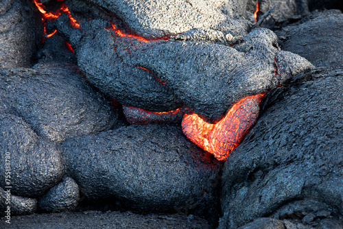 Heart shaped red glowing lava detail on lava field in Hawaii Volcanoes National Park, USA photo