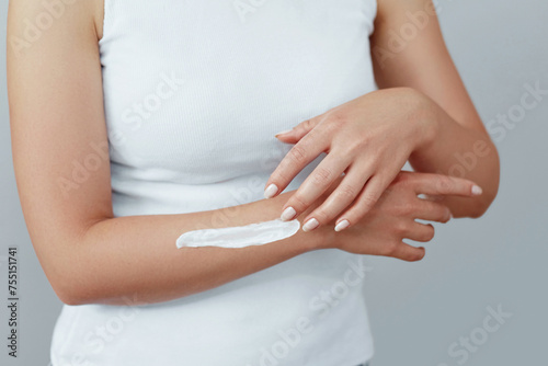 Wallpaper Mural Closeup shot of woman hands holding cream and applying moisturizing hand cream. Beautiful female hands with cream. Hand Skin Care. A woman uses body lotion on your arms. Beauty And Body Care Concept Torontodigital.ca