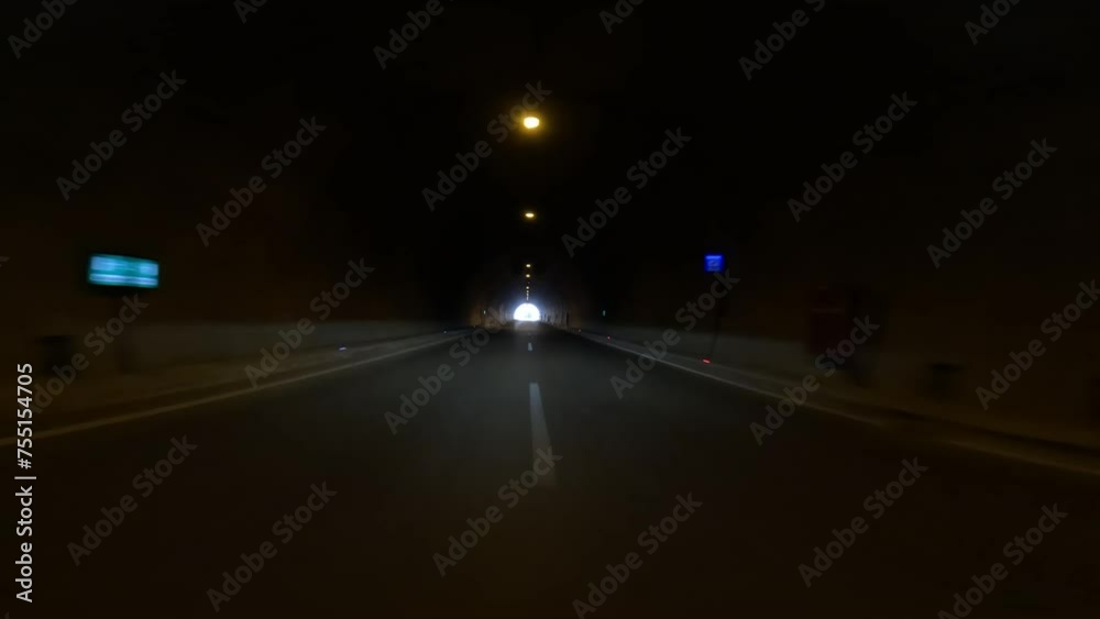 Car exits road tunnel, capturing road tunnel, road trip essence. Video focuses on road tunnel, road trip dynamics from within car. Highlights road tunnel, road trip journey, showcasing exit Car exits road tunnel, capturing road tunnel, road trip essence. Video focuses on road tunnel, road trip dynamics from within car. Highlights road tunnel, road trip journey, showcasing exit